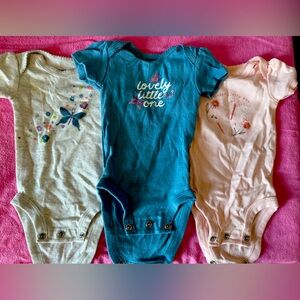 Three Carter’s newborn onesies.